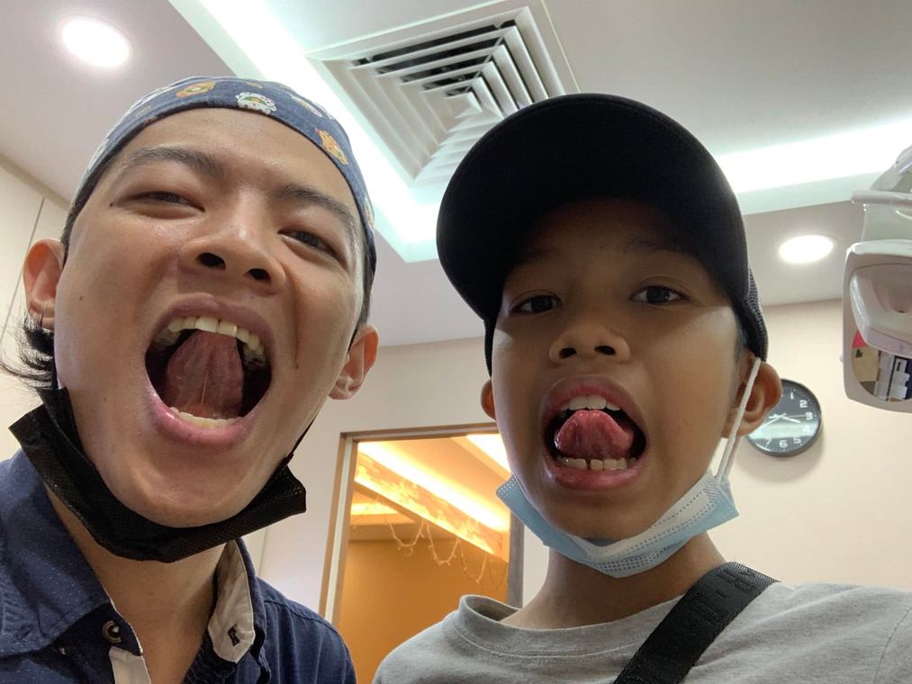 Dr. Arthur and a young patient smiling at iCare Dental IOI City Mall Putrajaya