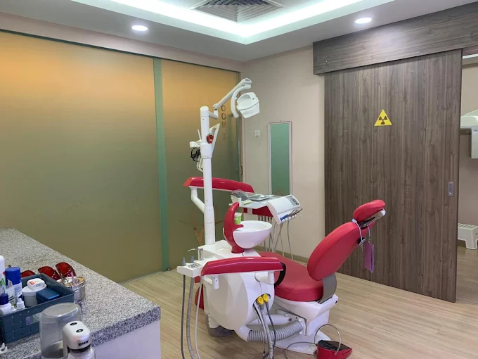 A modern treatment room with a dental chair at iCare Dental