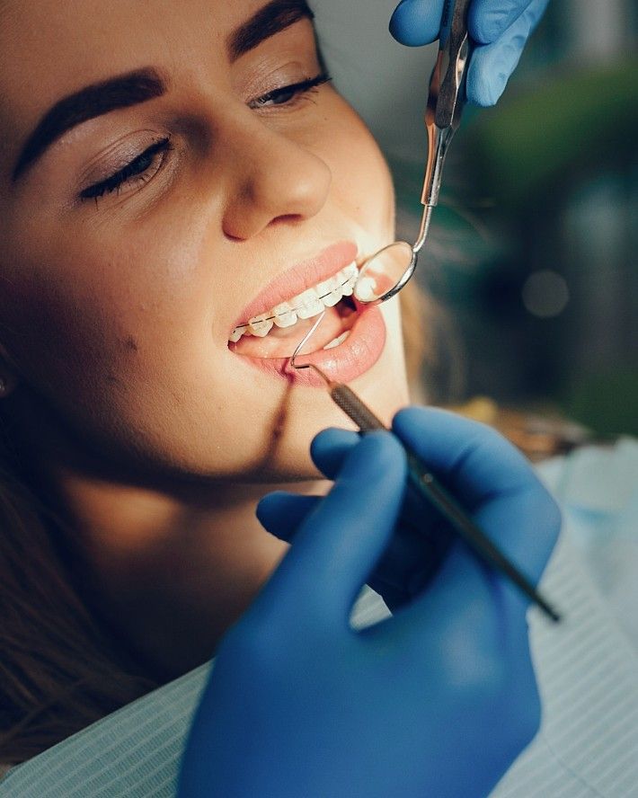 Dentist examining a patient's braces at iCare Dental IOI City Mall Putrajaya