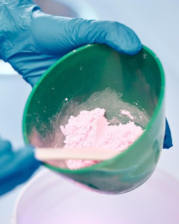 Dental technician mixing impression material used to custom-fit a denture at iCare Dental IOI City Mall Putrajaya