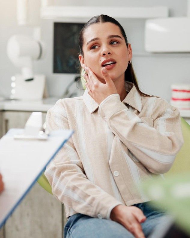 Patient describing discomfort from a lost filling or crown to her dentist at iCare Dental IOI City Mall Putrajaya