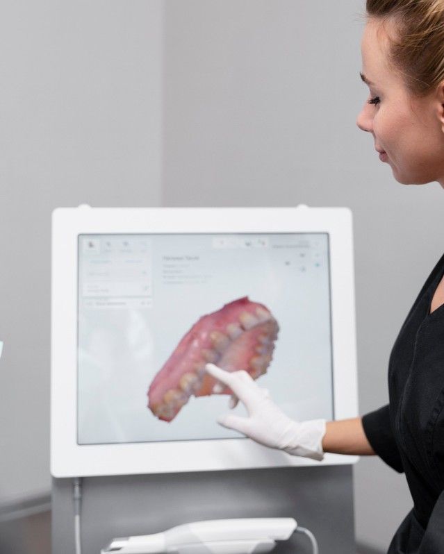 Dental assistant reviewing a patient's 3D digital scan on screen at iCare Dental IOI City Mall Putrajaya